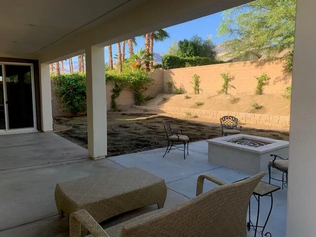 a lawn chairs sitting in the middle of a backyard