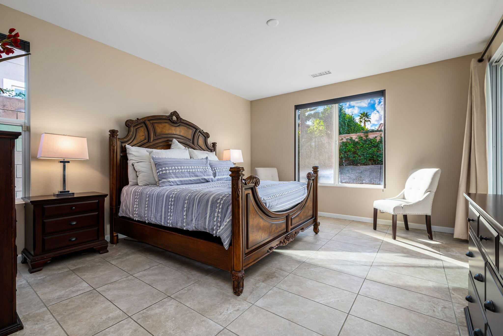 60237 Angora Court La Quinta, CA 92253 - Photo 19 of 75 a bedroom with a bed and a lamp next to a window