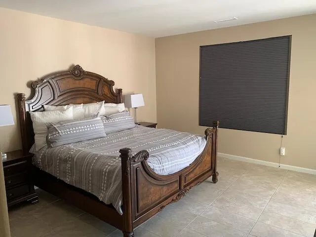 a bedroom with a bed and a night stand