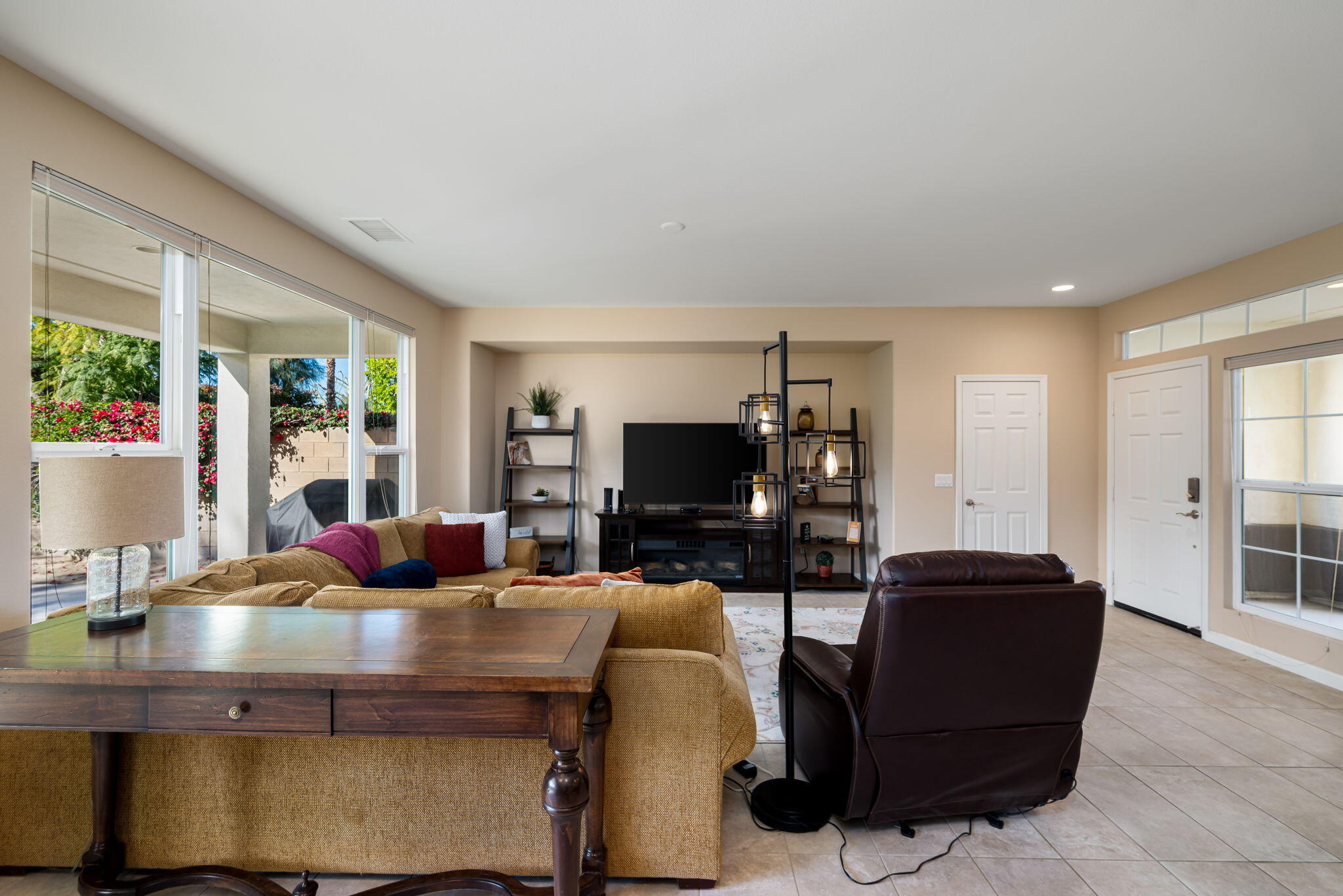 60237 Angora Court La Quinta, CA 92253 - Photo 8 of 75 a living room with furniture a flat screen tv and a large window