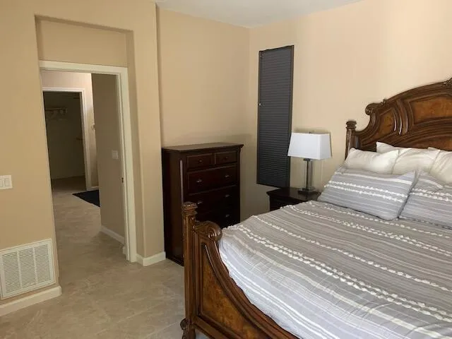 a bedroom with a bed and a lamp