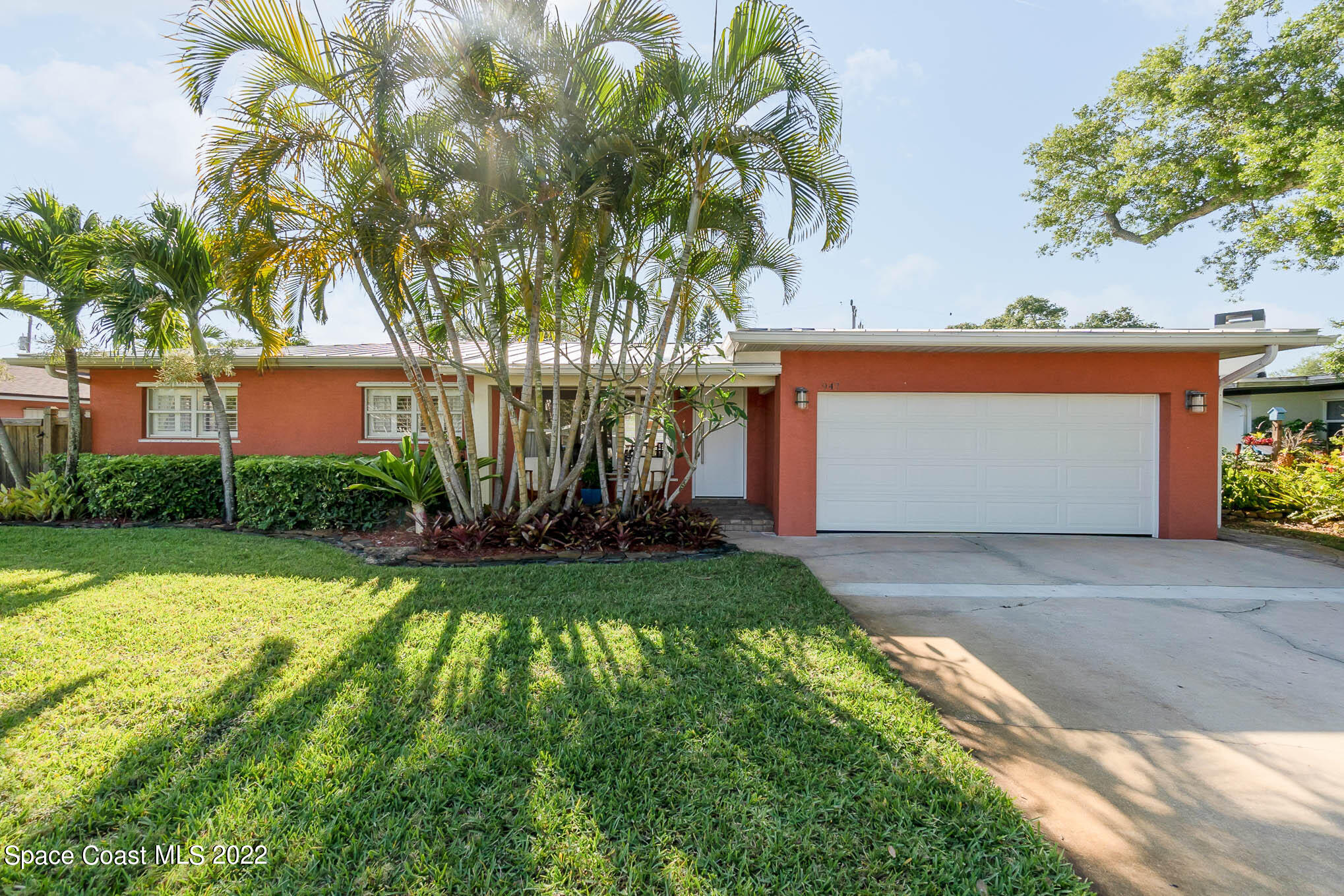 947 Santa Cruz Road Cocoa Beach, FL 32931 - Photo 1 of 29 a front view of a house with garden