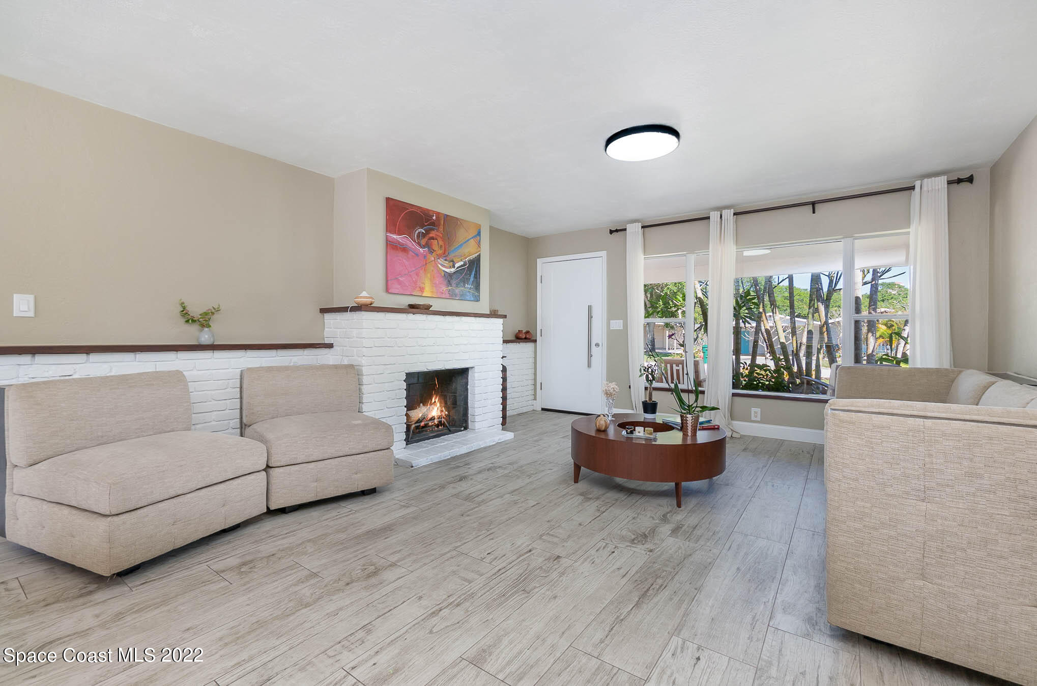 947 Santa Cruz Road Cocoa Beach, FL 32931 - Photo 11 of 29 a living room with furniture and a fireplace