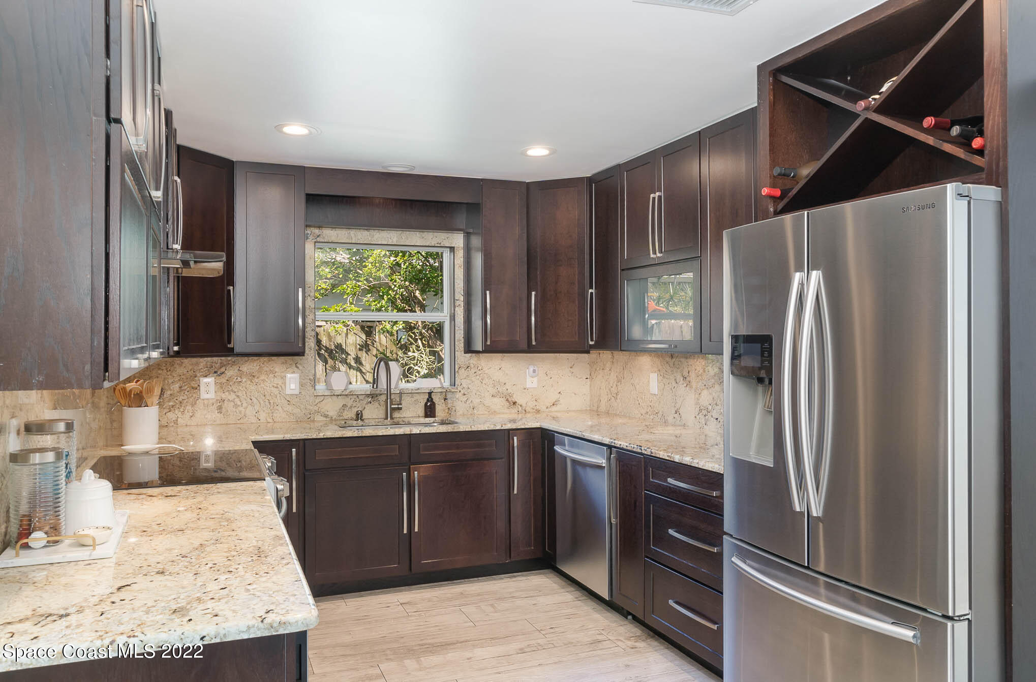 947 Santa Cruz Road Cocoa Beach, FL 32931 - Photo 15 of 29 a kitchen with stainless steel appliances granite countertop a refrigerator and a sink