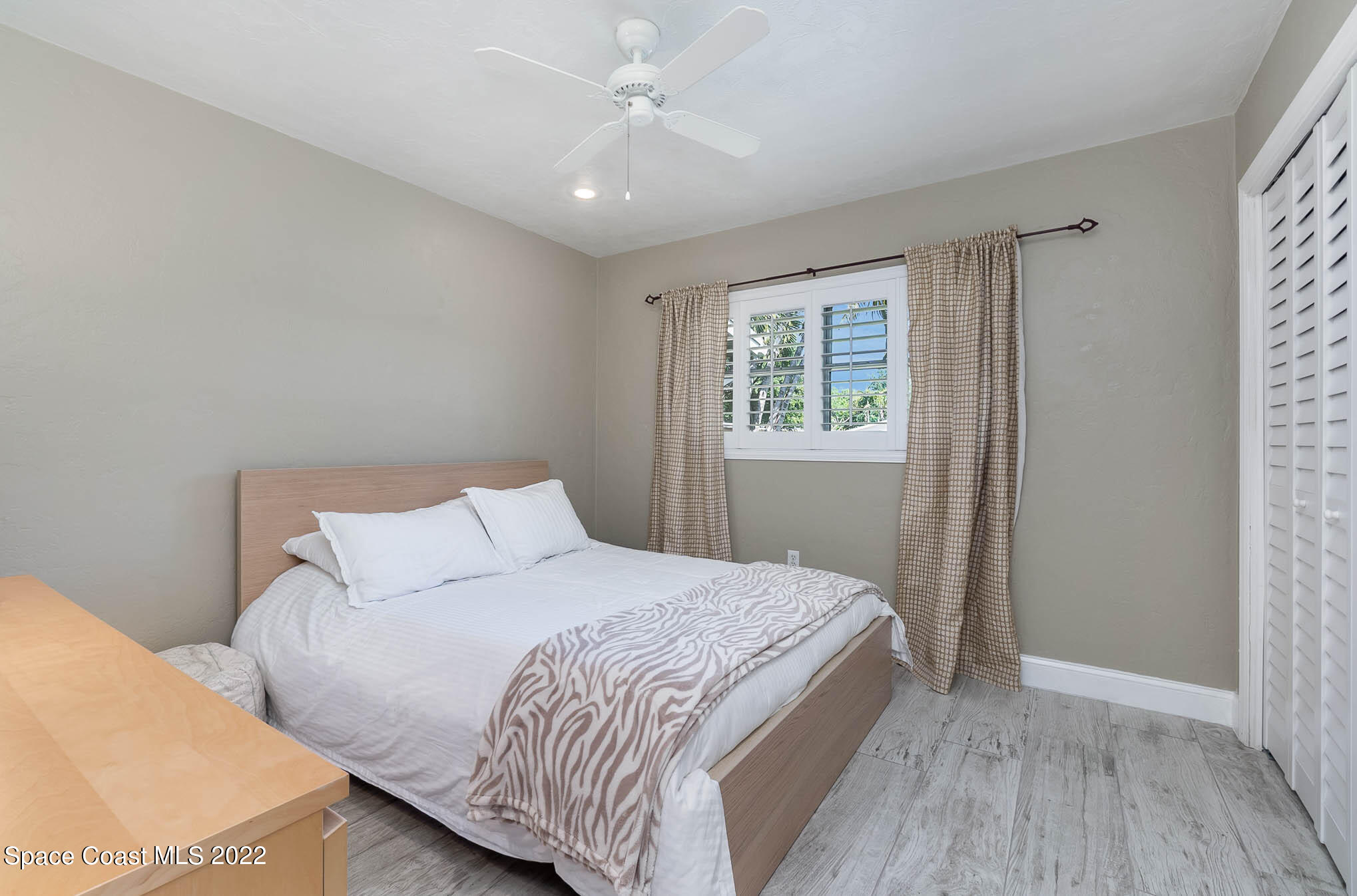 947 Santa Cruz Road Cocoa Beach, FL 32931 - Photo 22 of 29 a bedroom with a bed and a window