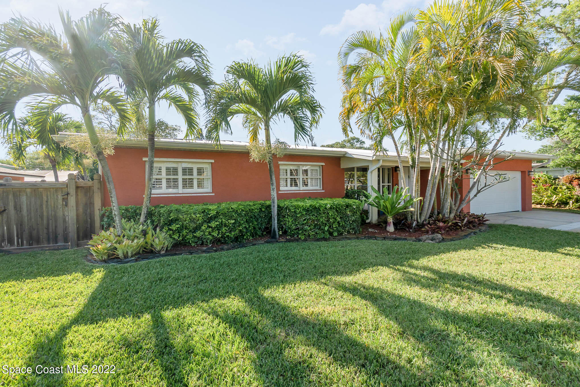 947 Santa Cruz Road Cocoa Beach, FL 32931 - Photo 3 of 29 a front view of house with yard and green space