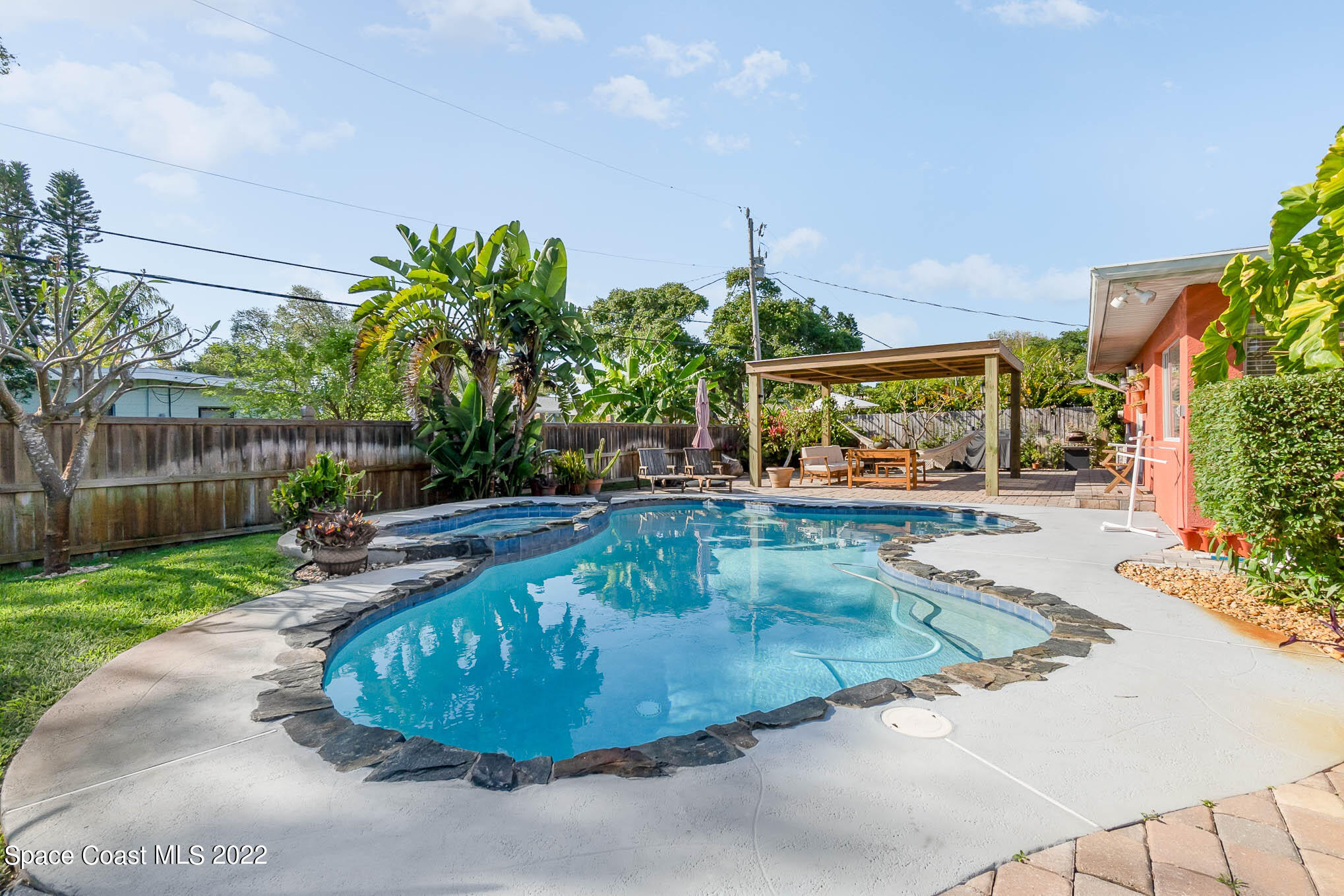 947 Santa Cruz Road Cocoa Beach, FL 32931 - Photo 7 of 29 a view of a swimming pool with a patio
