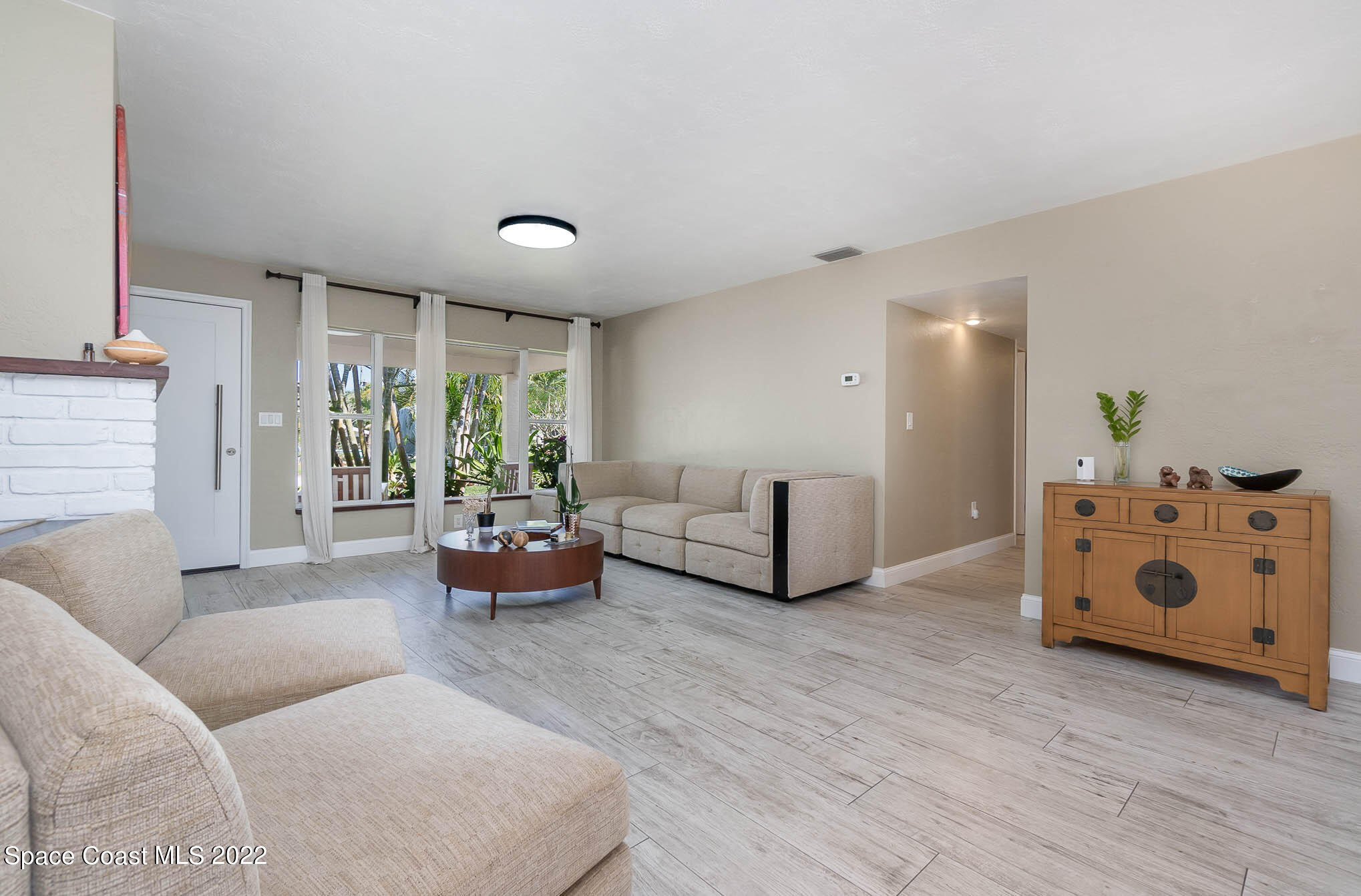947 Santa Cruz Road Cocoa Beach, FL 32931 - Photo 10 of 29 a living room with furniture and a large window