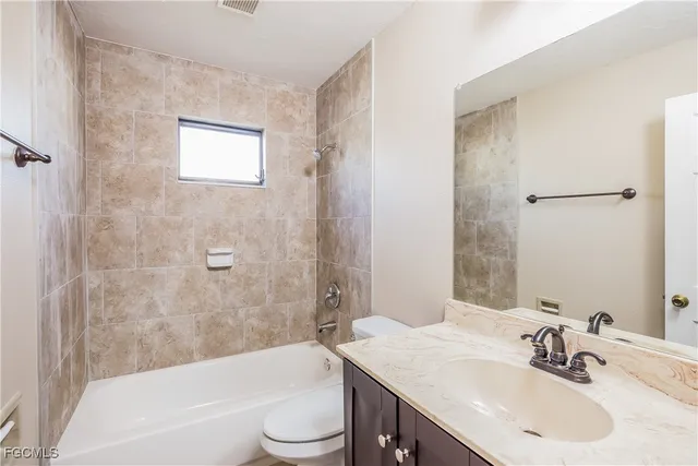 a bathroom with a sink toilet and bathtub