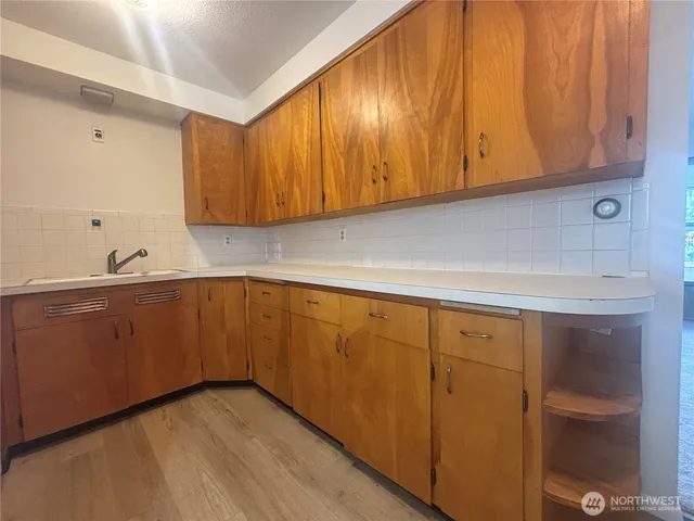 a kitchen with granite countertop cabinets stainless steel appliances and wooden cabinets