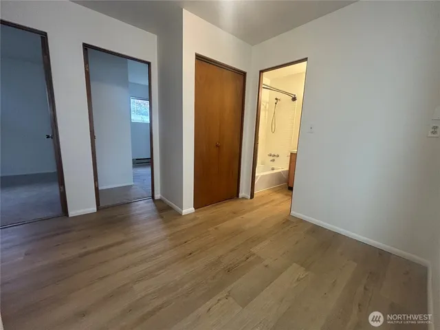 a view of a hallway with wooden floor