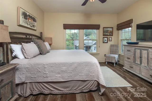 a bed sitting in a bedroom next to a window