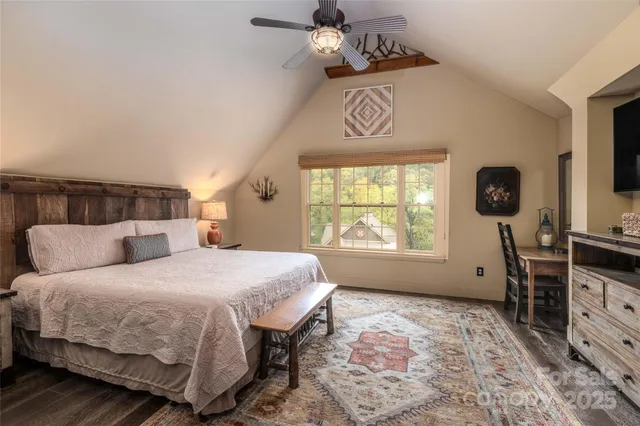 a bedroom with a bed a dresser next to a window