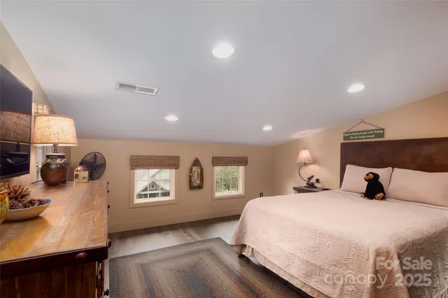 a bedroom with a bed window and dresser