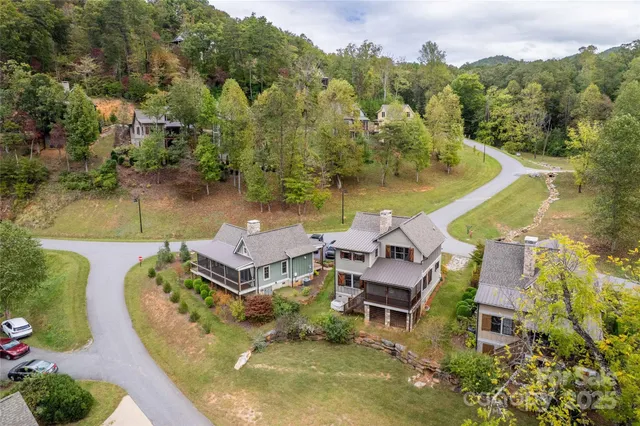 an aerial view of a house with swimming pool and lake view