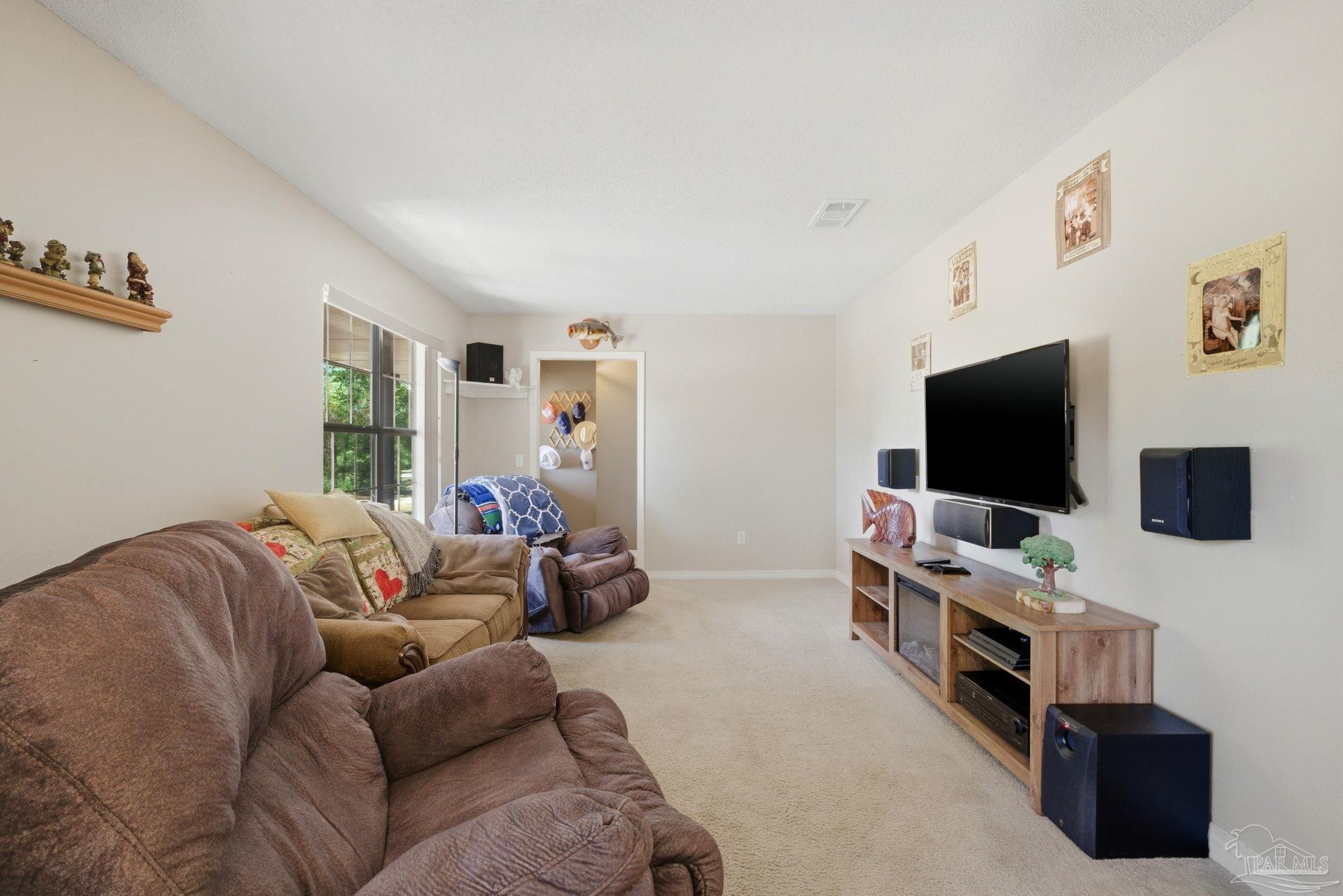 5121 Keyser Mill Road Baker, FL 32531 - Photo 8 of 52 a living room with furniture and a flat screen tv