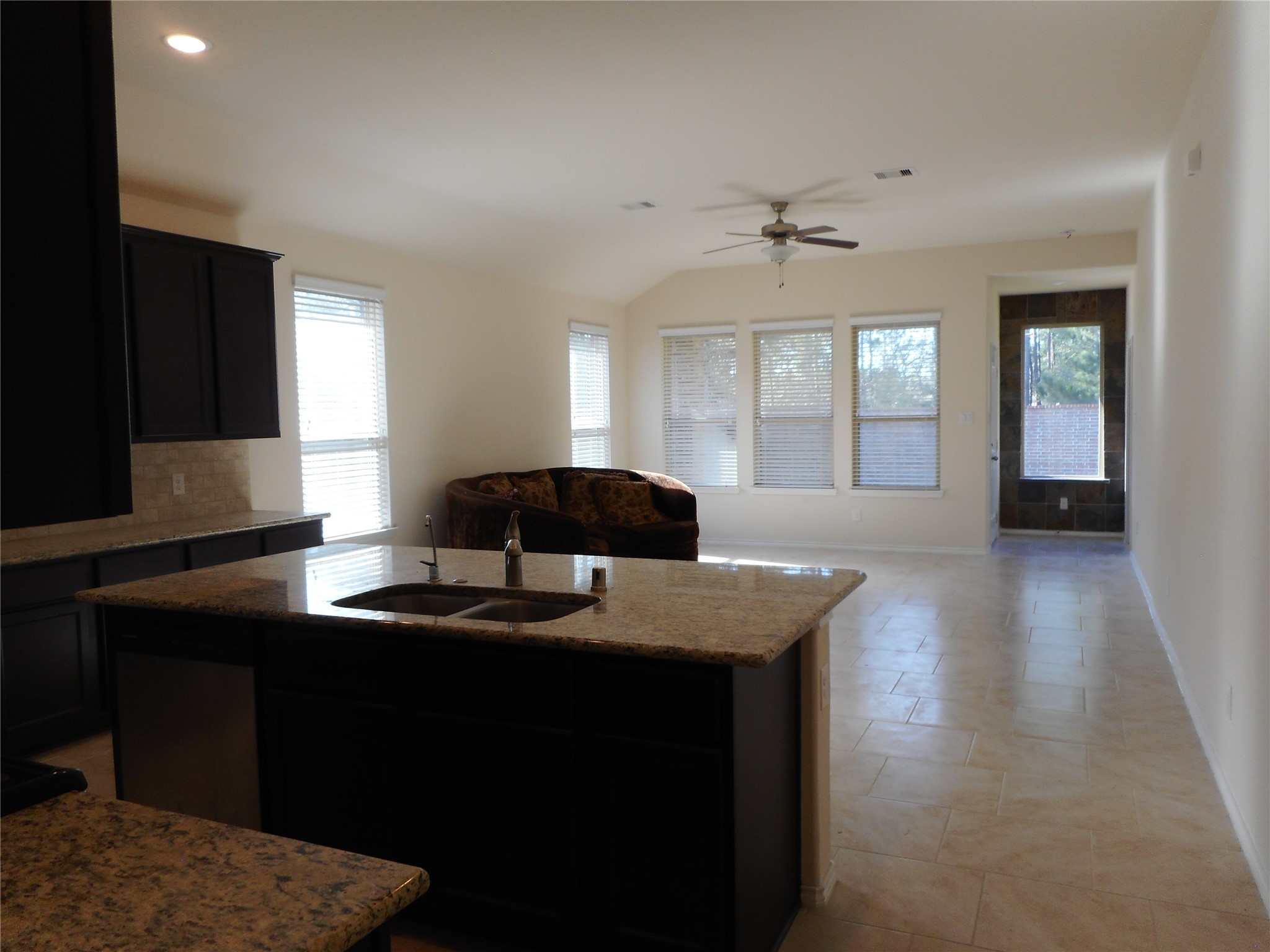 14021 Buffalo Gap Trail Conroe, TX 77384 - Photo 11 of 20 a kitchen with granite countertop a sink window and cabinets