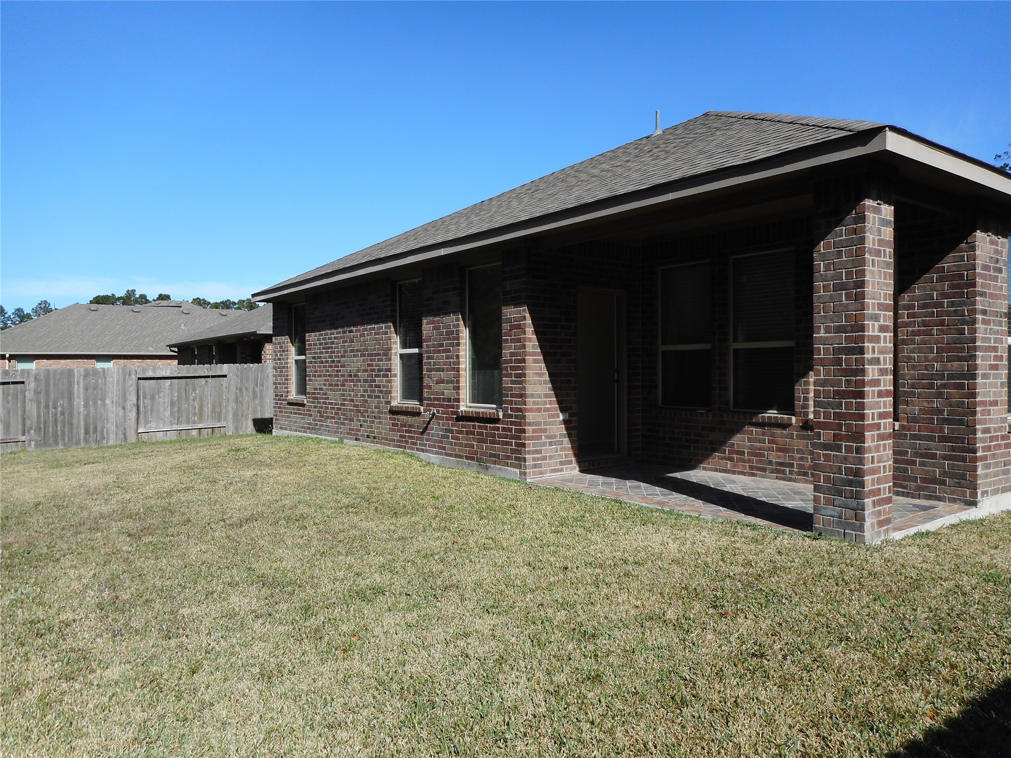 14021 Buffalo Gap Trail Conroe, TX 77384 - Photo 5 of 20 a black and white building with a yard