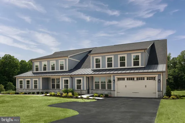 a front view of building with yard and trees