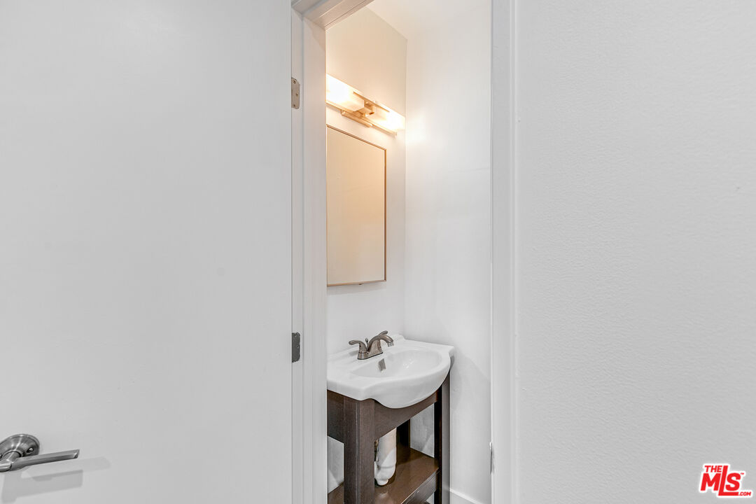 1837 North La Brea Avenue, Unit 2 Los Angeles, CA 90046 - Photo 12 of 19 a bathroom with a sink a mirror and a window