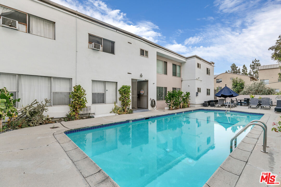 1837 North La Brea Avenue, Unit 2 Los Angeles, CA 90046 - Photo 17 of 19 a swimming pool with outdoor seating and yard