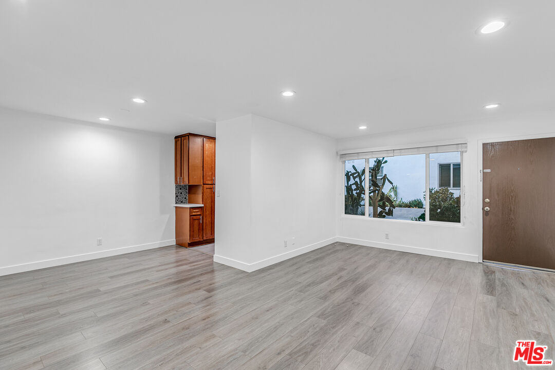 1837 North La Brea Avenue, Unit 2 Los Angeles, CA 90046 - Photo 2 of 19 a view of an empty room with wooden floor and a window