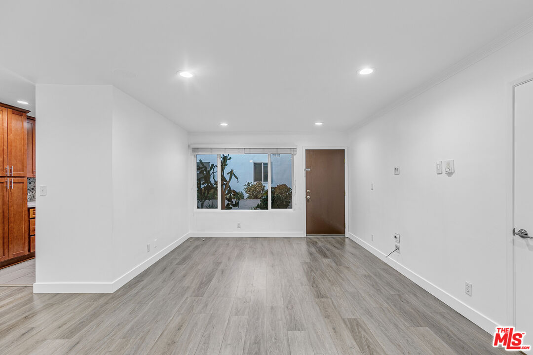 1837 North La Brea Avenue, Unit 2 Los Angeles, CA 90046 - Photo 3 of 19 a view of an empty room with wooden floor and a window