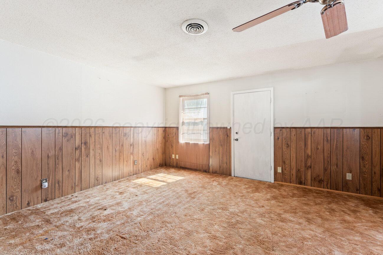 4305 South Bonham Street Amarillo, TX 79110 - Photo 23 of 48 a view of an empty room with wooden walls