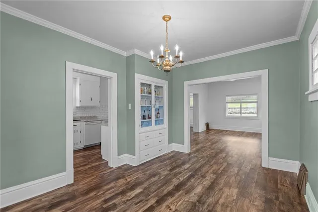 a view of a livingroom with wooden floor and a chandelier