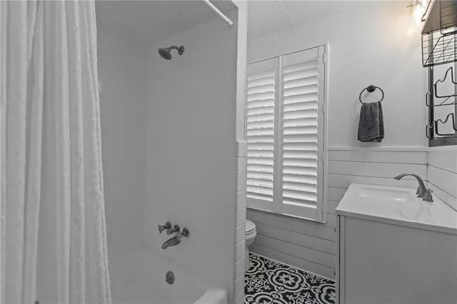 a bathroom with a bathtub a shower and a sink