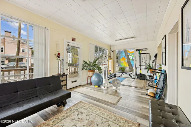 a living room with furniture and wooden floor