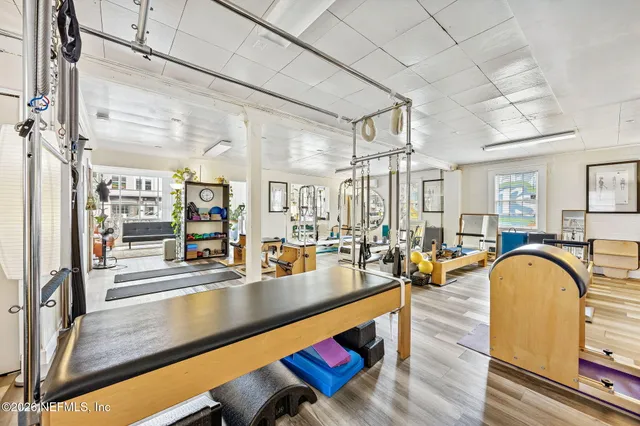 a living room with furniture pool table and chairs