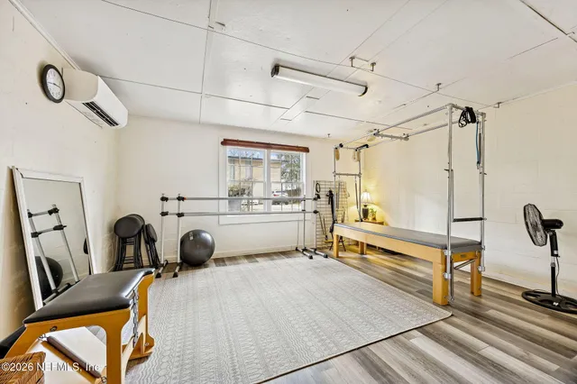 a room with a bed a couch and a chandelier