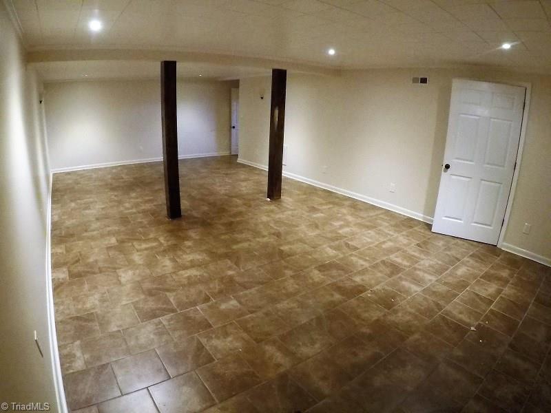 1020 Old Mail Rte Road King, NC 27021 - Photo 29 of 30 Basement w storage leads to two car pull in garage. Great for Rec room, theatre room or home office