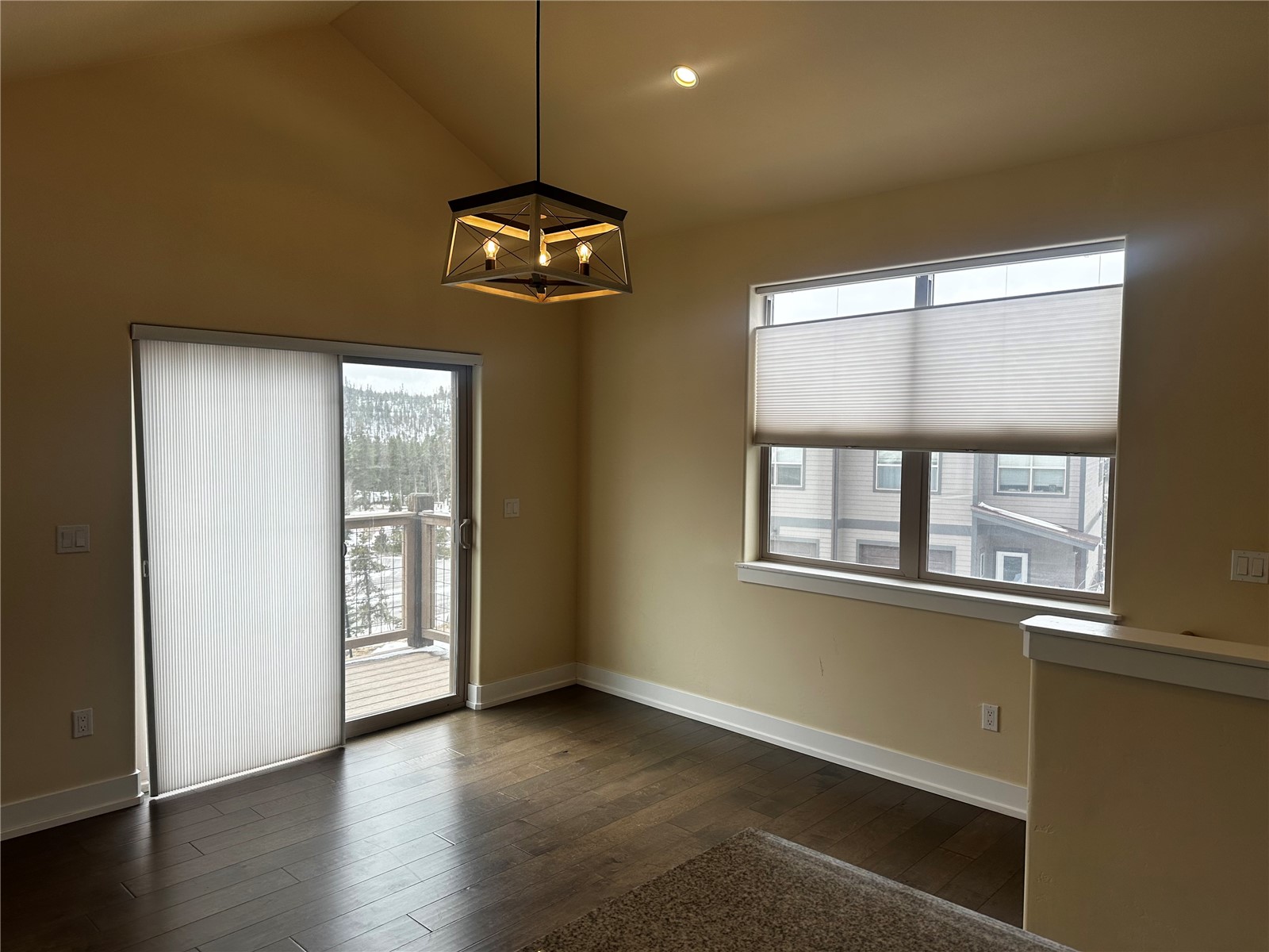 141 Wayback Drive, Unit B Keystone, CO 80435 - Photo 7 of 16 an empty room with wooden floor a chandelier fan and windows