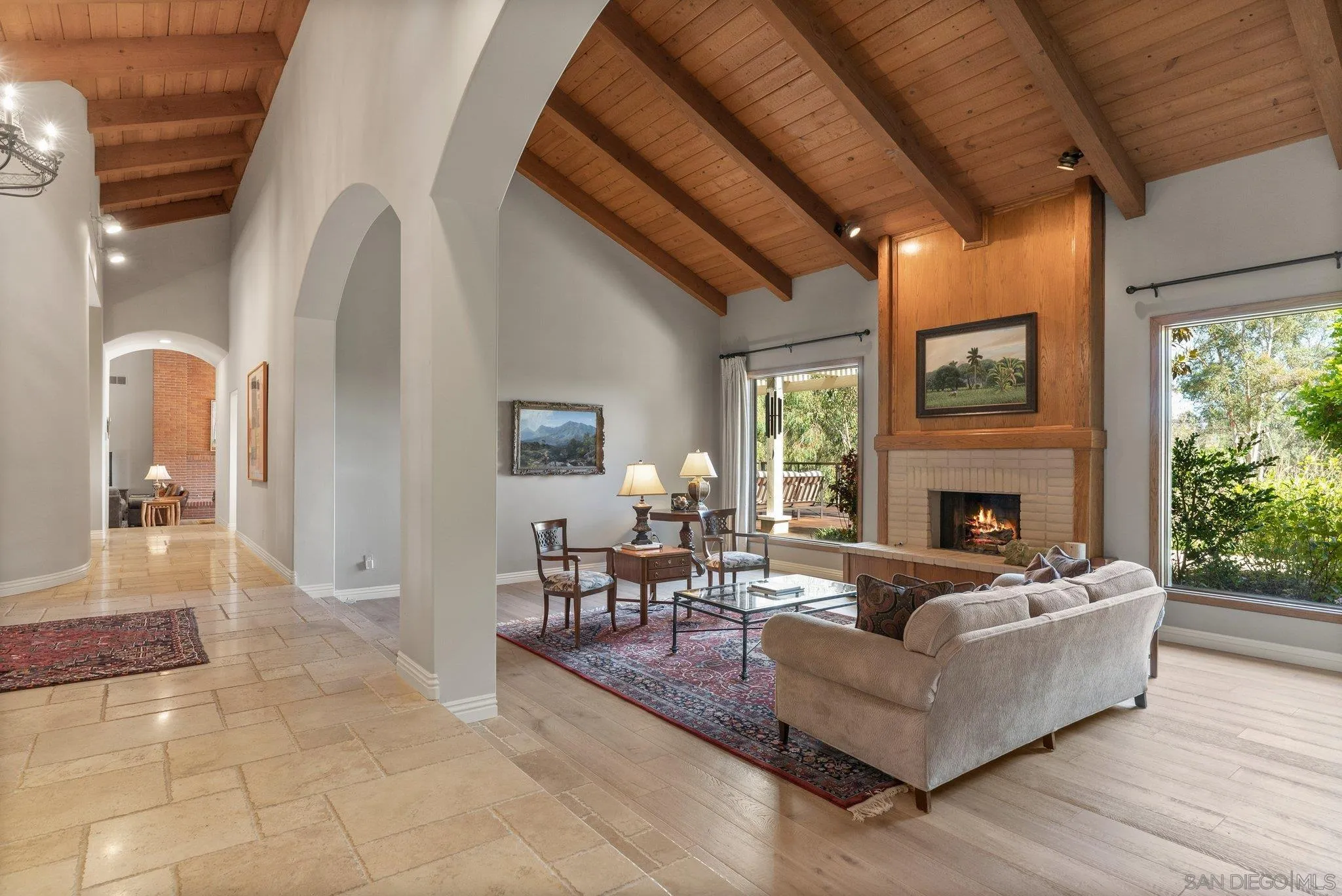 6286 Avenida Floresta Rancho Santa Fe, CA 92067 - Photo 16 of 69 a living room with furniture a fireplace and a floor to ceiling window