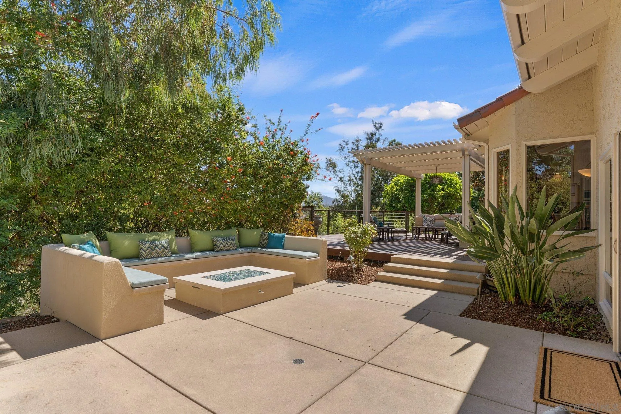 6286 Avenida Floresta Rancho Santa Fe, CA 92067 - Photo 27 of 69 a view of a patio with a table and chairs under an umbrella