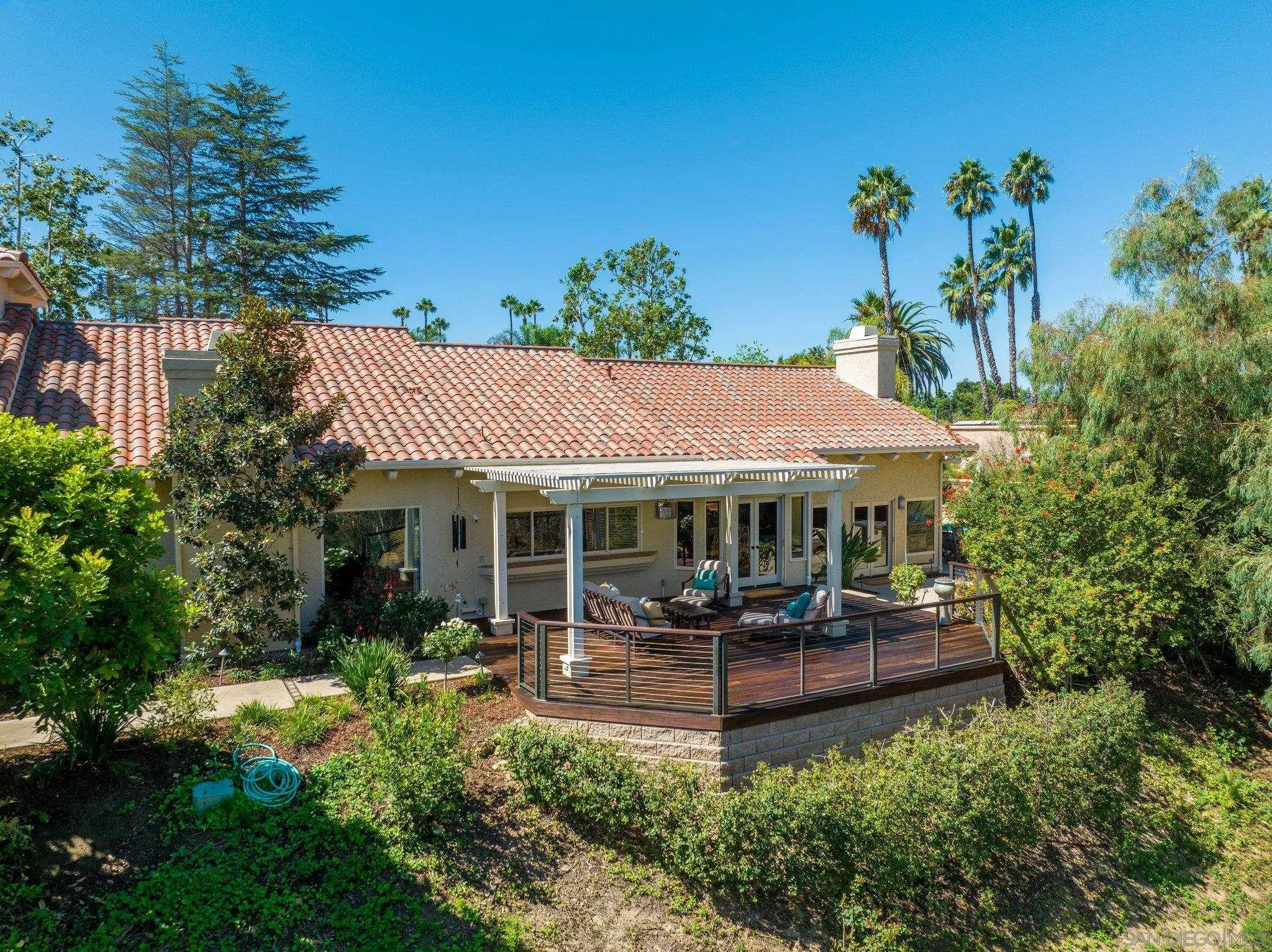 6286 Avenida Floresta Rancho Santa Fe, CA 92067 - Photo 30 of 69 a view of a patio with table and chairs potted plants and large tree
