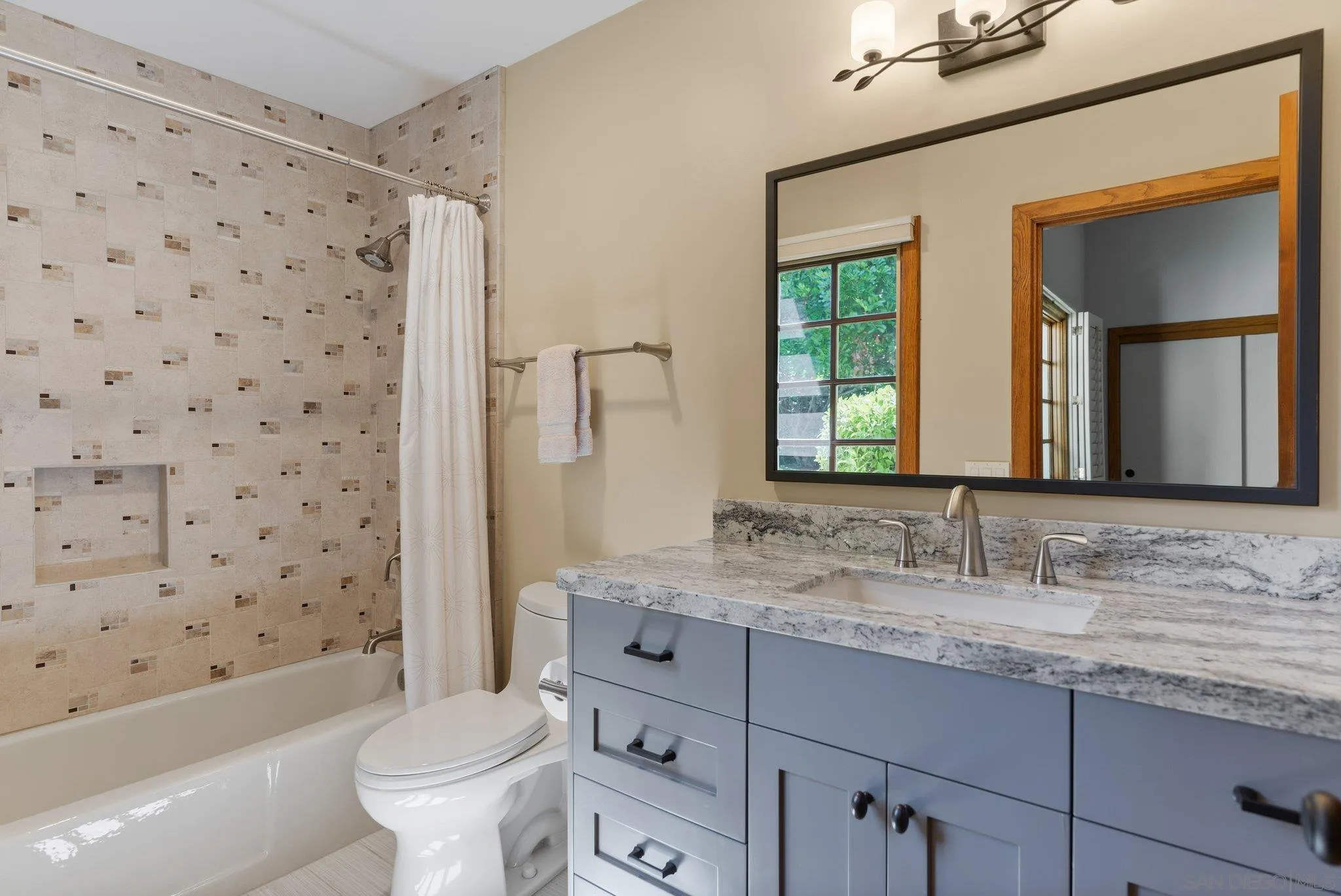 6286 Avenida Floresta Rancho Santa Fe, CA 92067 - Photo 32 of 69 a bathroom with a granite countertop toilet a sink a mirror a bathtub and shower