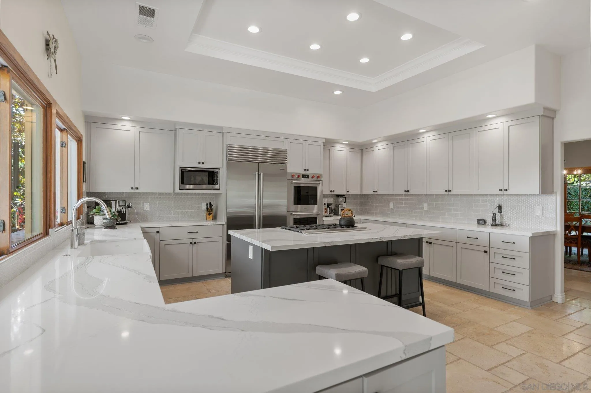 6286 Avenida Floresta Rancho Santa Fe, CA 92067 - Photo 4 of 69 a room with a sink dishwasher stove and white cabinets with wooden floor