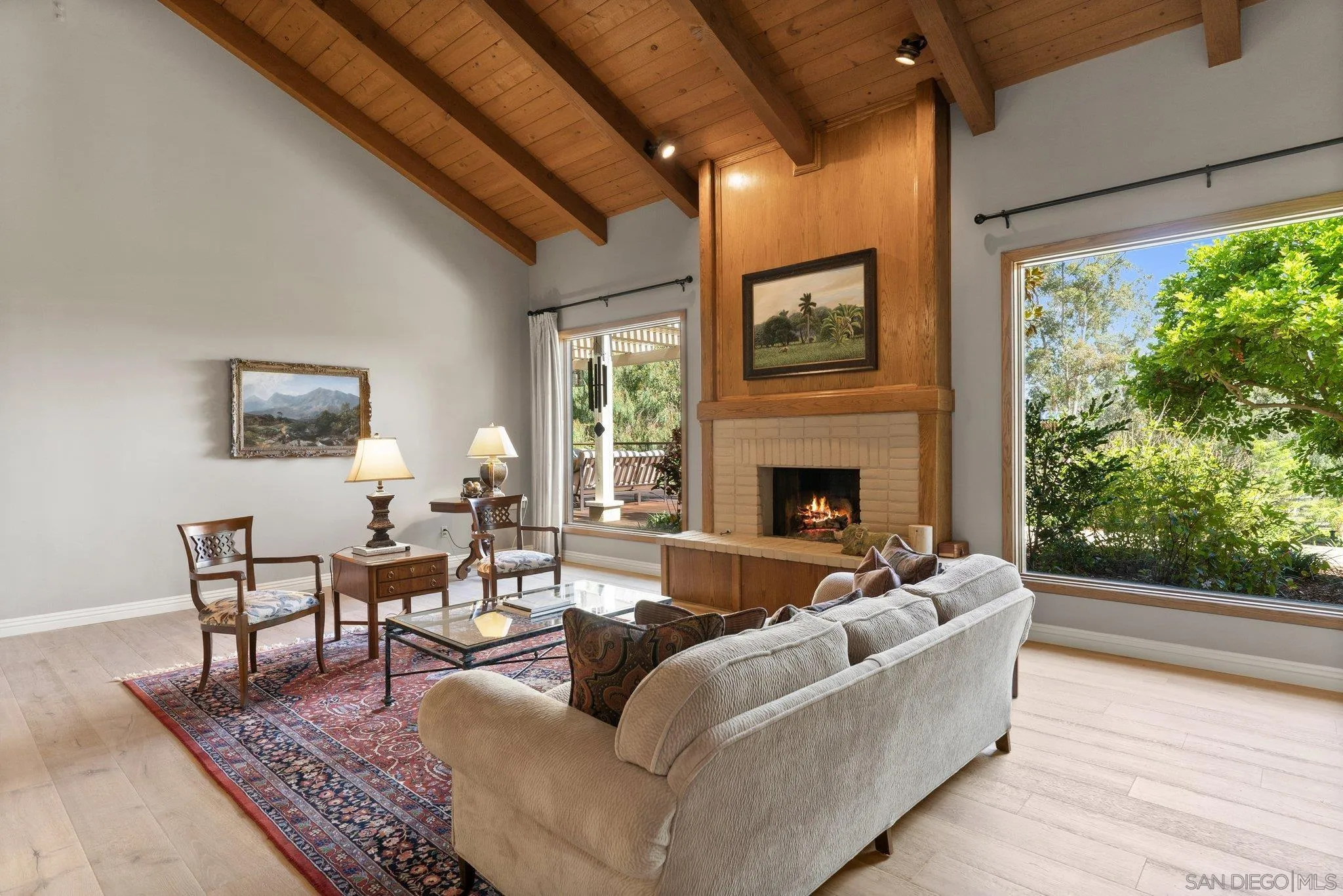 6286 Avenida Floresta Rancho Santa Fe, CA 92067 - Photo 45 of 69 a living room with furniture a fireplace and a floor to ceiling window