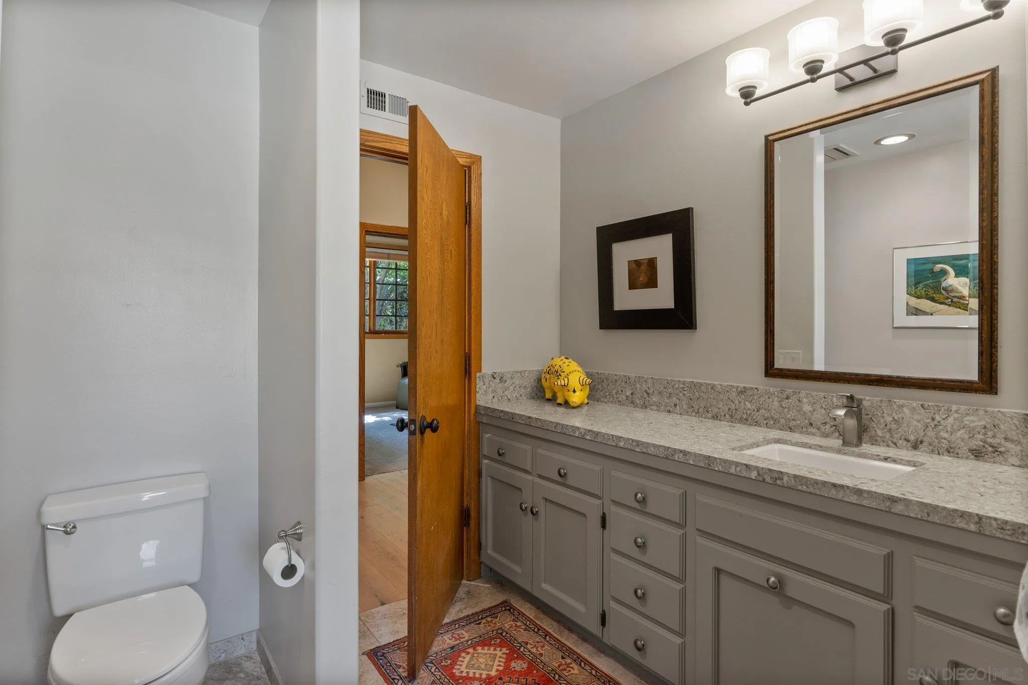 6286 Avenida Floresta Rancho Santa Fe, CA 92067 - Photo 48 of 69 a bathroom with a granite countertop sink vanity mirror and toilet