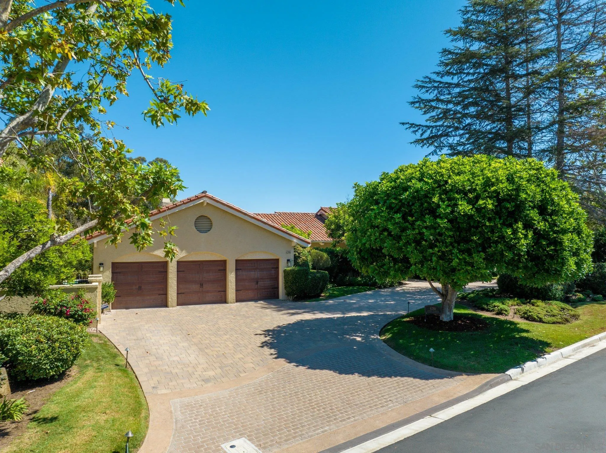 6286 Avenida Floresta Rancho Santa Fe, CA 92067 - Photo 5 of 69 a front view of a house with a yard and trees