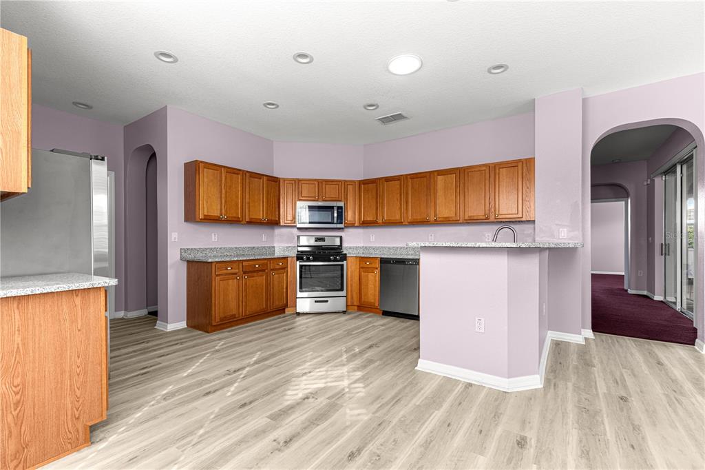 8084 South W 81st Loop Ocala, FL 34476 - Photo 13 of 37 a kitchen with stainless steel appliances a stove top oven and sink