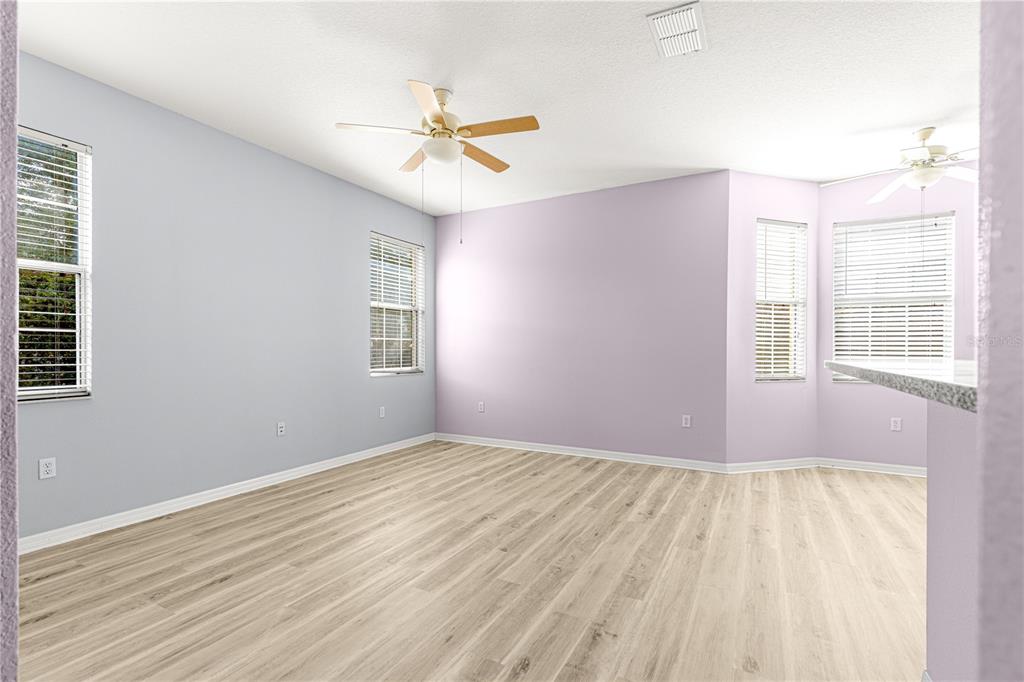 8084 South W 81st Loop Ocala, FL 34476 - Photo 15 of 37 a view of an empty room with wooden floor and a window