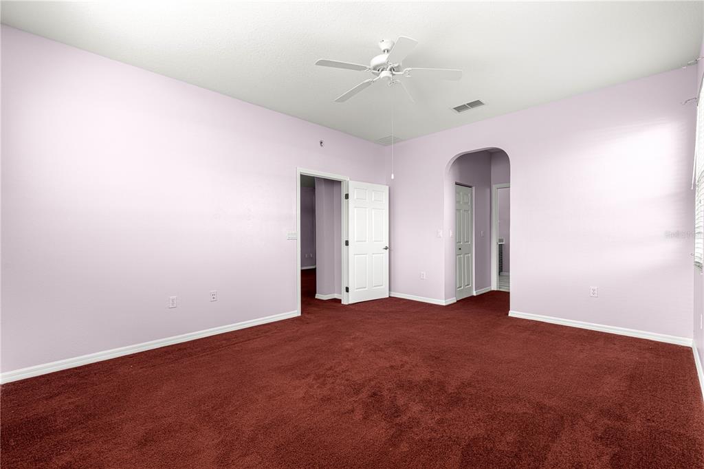 8084 South W 81st Loop Ocala, FL 34476 - Photo 17 of 37 an empty room with a ceiling fan and a window