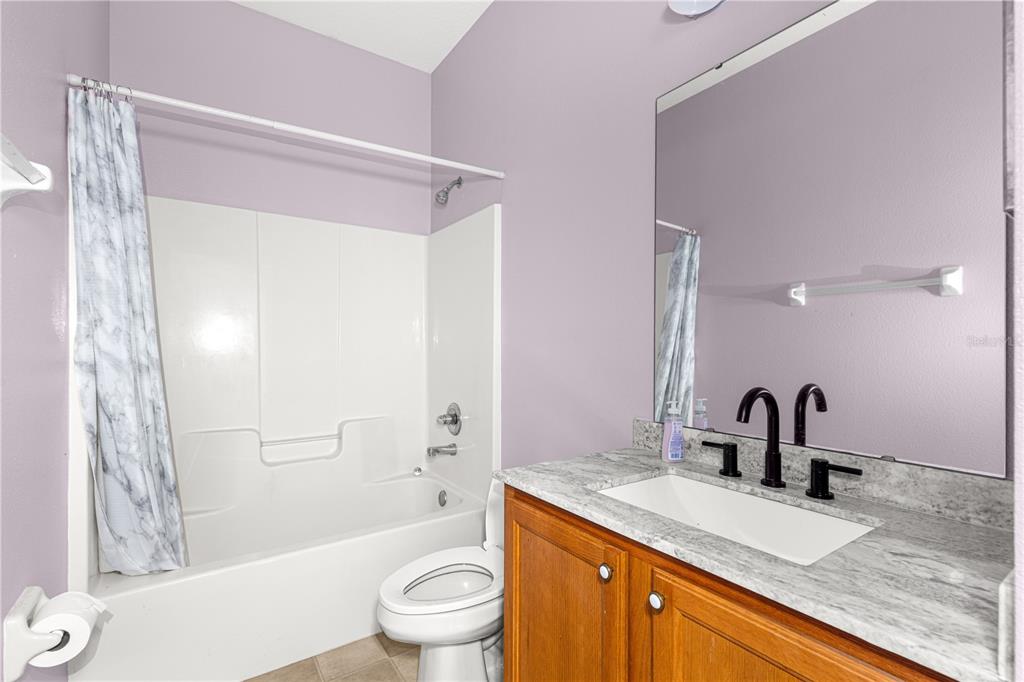 8084 South W 81st Loop Ocala, FL 34476 - Photo 24 of 37 a bathroom with a granite countertop sink toilet and shower