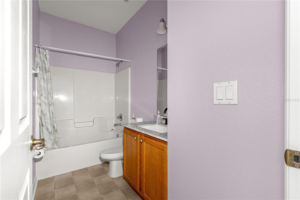 8084 South W 81st Loop Ocala, FL 34476 - Photo 25 of 37 a bathroom with a granite countertop sink toilet and shower