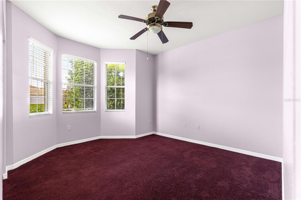 8084 South W 81st Loop Ocala, FL 34476 - Photo 27 of 37 a view of a big room with windows and chandelier fan