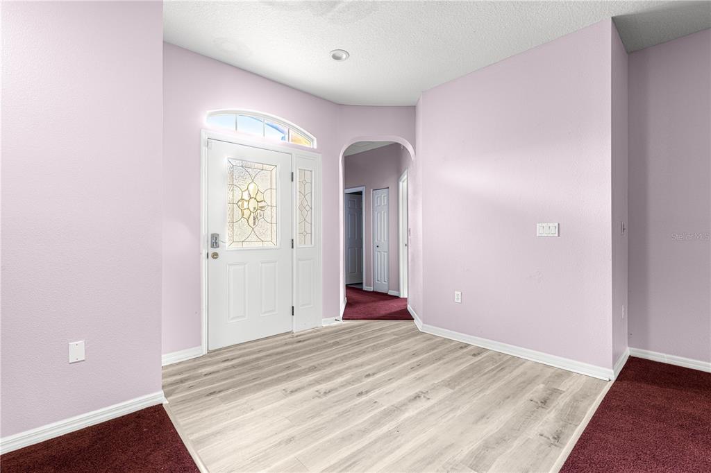 8084 South W 81st Loop Ocala, FL 34476 - Photo 8 of 37 a view of a livingroom with wooden floor and a bathroom